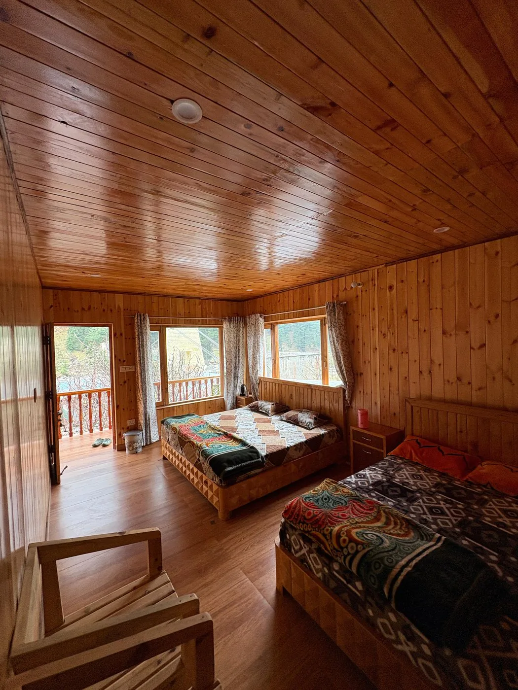 First-floor room with two king beds and pine wood interiors